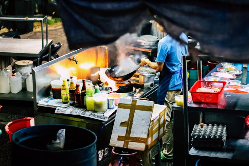 Food Stalls - man in white t-shirt cooking