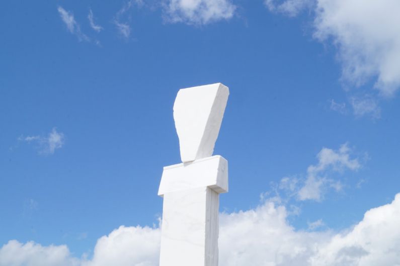 Art Installations - a large white sculpture sitting on top of a lush green field