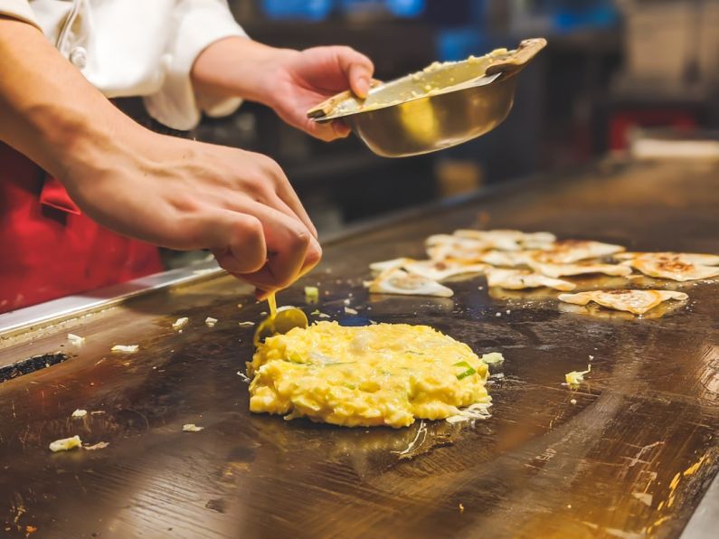 Okonomiyaki - person holding stainless steel spoon